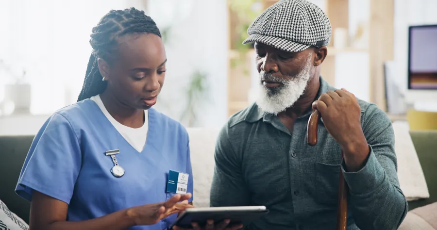 A nurse going through a care plan with an older man at home