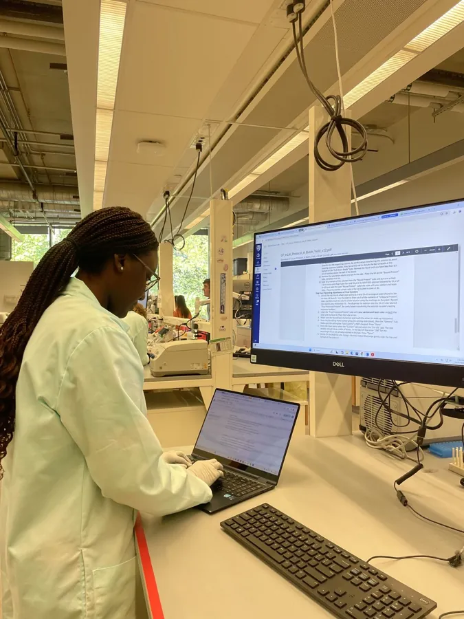 A research coordinator working at a laboratory computer